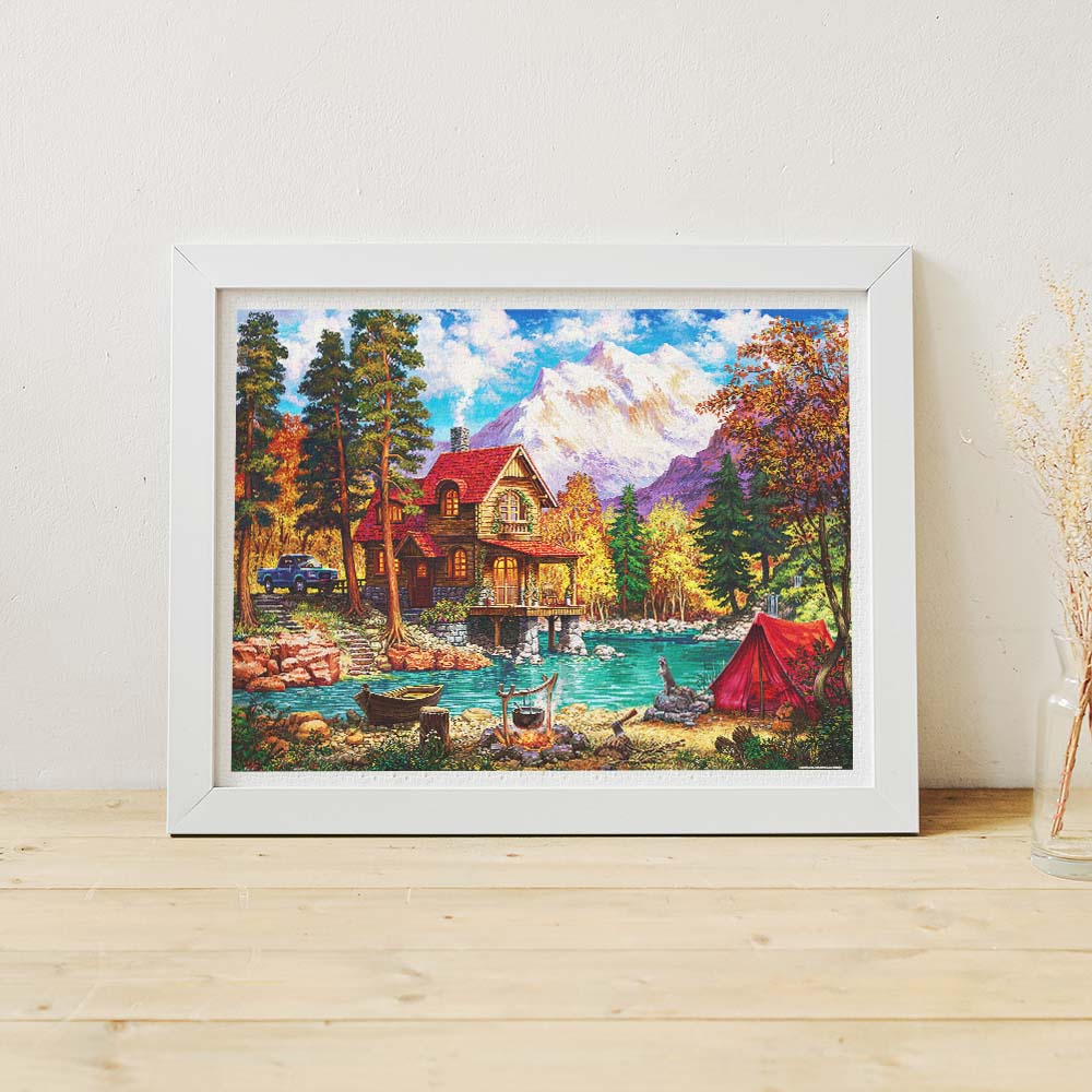 PieceRelax | 1200 piece puzzle. Escape to tranquility with PieceRelax puzzle. This picturesque scene includes a cozy cabin by the lake and a majestic mountain backdrop. 