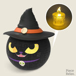 PieceRelax - Puzzle Candle Light - Magic Cat Puzzle Candle Light." This captivating 3D puzzle features a mysterious black cat wearing a witch's hat, illuminated by a flickering LED light. Perfect for adding a touch of magic and fun to your home, it’s an eye-catching decoration for any room. With PieceRelax, you’ll always get there, making every Halloween special.